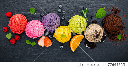 Various of ice cream flavor ball blueberry ,lime ,pistachio ,almond ,orange ,chocolate and vanilla set up on dark stone background . Summer and Sweet menu concept. Various of ice cream flavor ball blueberry ,lime ,pistachio ,almond ,orange ,chocolate and vanilla set up on dark stone background . Summer and Sweet menu concept. 77665235