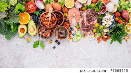 Ketogenic low carbs diet concept. Ingredients for healthy foods selection set up on white concrete background. Ketogenic low carbs diet concept. Ingredients for healthy foods selection set up on white concrete background. 77665336