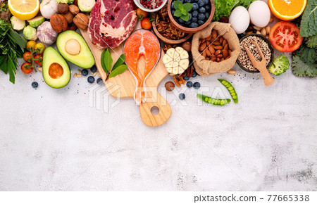 Ketogenic low carbs diet concept. Ingredients for healthy foods selection set up on white concrete background. Ketogenic low carbs diet concept. Ingredients for healthy foods selection set up on white concrete background. 77665338