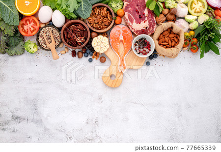 Ketogenic low carbs diet concept. Ingredients for healthy foods selection set up on white concrete background. Ketogenic low carbs diet concept. Ingredients for healthy foods selection set up on white concrete background. 77665339
