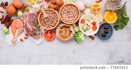 Ketogenic low carbs diet concept. Ingredients for healthy foods selection set up on white concrete background. Ketogenic low carbs diet concept. Ingredients for healthy foods selection set up on white concrete background. 77665423