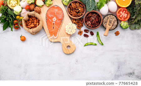 Ketogenic low carbs diet concept. Ingredients for healthy foods selection set up on white concrete background. Ketogenic low carbs diet concept. Ingredients for healthy foods selection set up on white concrete background. 77665428