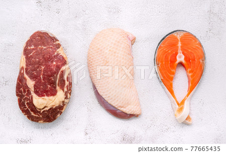 Steak concept with salmon  steak, rib eye steak and duck breast set up on white concrete background. 77665435