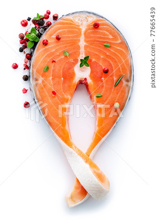 Fresh salmon fillet sliced isolate on white background. Piece of fresh salmon steak cut flat lay on white background. Fresh salmon fillet sliced isolate on white background. Piece of fresh salmon steak cut flat lay on white background. 77665439