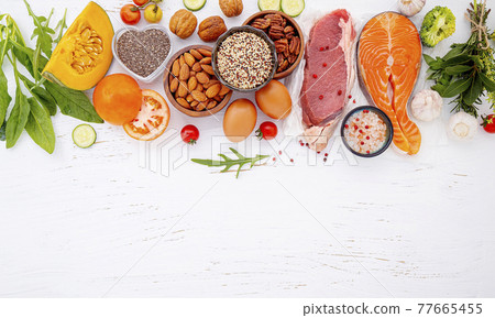 Ketogenic low carbs diet concept. Ingredients for healthy foods selection on white wooden background. Balanced healthy ingredients of unsaturated fats for the heart and blood vessels. Ketogenic low carbs diet concept. Ingredients for healthy foods selection on white wooden background. Balanced healthy ingredients of unsaturated fats for the heart and blood vessels. 77665455