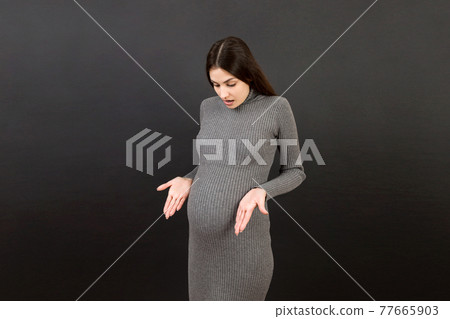 happy surprised pregnant woman posing isolated over colored background. copy space happy surprised pregnant woman posing isolated over colored background. copy space 77665903