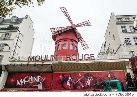 Moulin Rouge with a windmill on the streets of Paris, France Moulin Rouge with a windmill on the streets of Paris, France 77666049