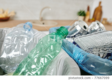 Trash bins with empty cans, plastic bottles and other waste Trash bins with empty cans, plastic bottles and other waste 77667099