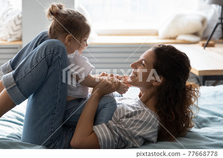Happy mom relax play with toddler daughter Happy mom relax play with toddler daughter 77668778