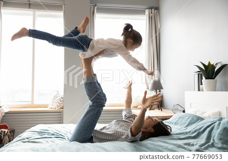 Happy mom have fun play with little daughter Happy mom have fun play with little daughter 77669053
