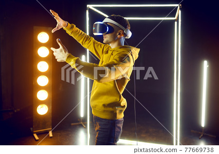 Gamer using virtual reality headset, front view 77669738