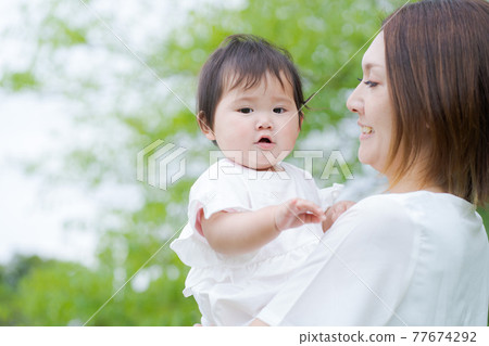 Baby hug green background 77674292