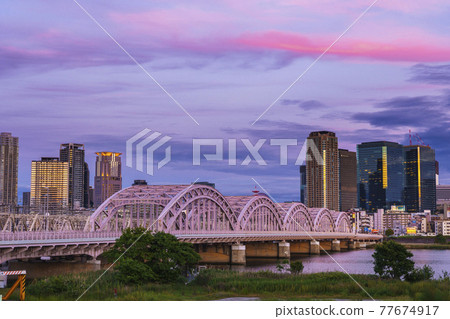Skyscrapers around Osaka Station seen from the Yodogawa riverbed Cityscape Evening 77674917
