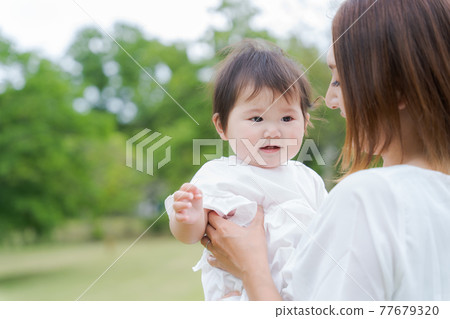 Baby hug green background 77679320