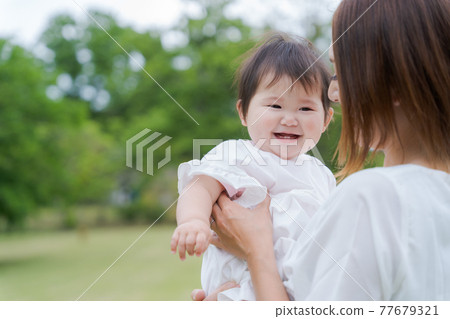 Baby hug green background 77679321