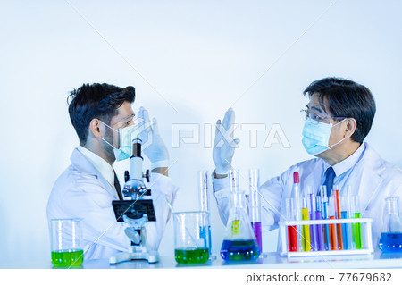 Couple male scientist handshake for success teamwork at laboratory. 77679682