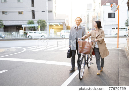 Couple returning from work 77679769