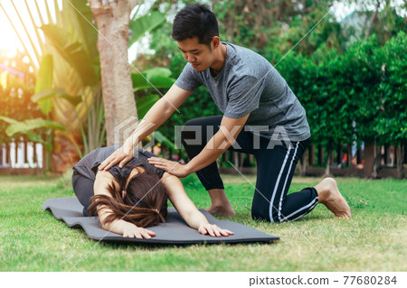 Young Asian couple man and woman practicing yoga in the garden in summer morning 77680284