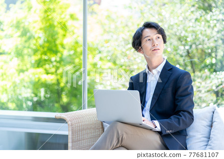 A man teleworking on the terrace. Shooting cooperation "+ SHIFT NOGIZAKA" A man teleworking on the terrace. Shooting cooperation "+ SHIFT NOGIZAKA" 77681107