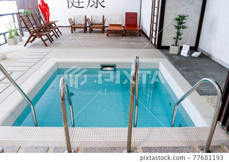 Indoor modern swimming pool in hotel spa center. Beautiful pool in the spa center, rest, relaxation. Indoor modern swimming pool in hotel spa center. Beautiful pool in the spa center, rest, relaxation. 77681193
