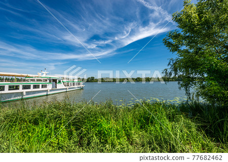 Mantua Lake or Mincio River with a moored Ferry Boat - Lombardy Italy 77682462