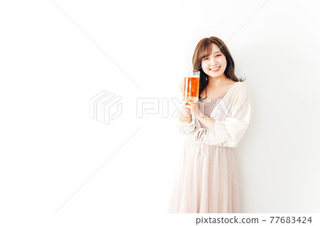 Young woman toasting with a jug 77683424