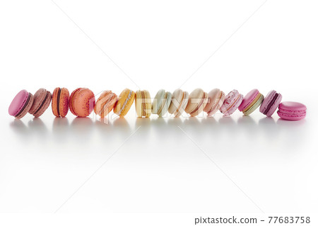 Horizontal line of colorful macarons on white background 77683758
