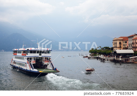 view of Bellagio village on the Como Lake with ferry boat, italy 77683924