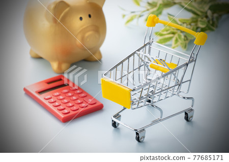 Image photo of shopping cart, golden piggy bank and calculator 77685171