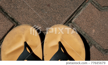 Slippers placed on an orange brick floor. Slippers placed on an orange brick floor. 77685679