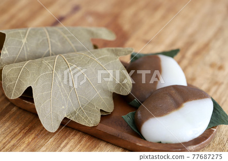 Bekomochi and Kashiwamochi served on a wooden plate Bekomochi and Kashiwamochi served on a wooden plate 77687275