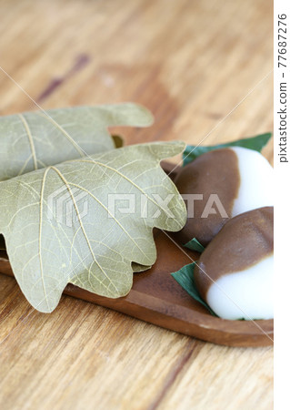 Bekomochi and Kashiwamochi served on a wooden plate 77687276