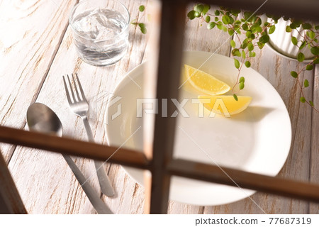 Table plate peeking through the window Table plate peeking through the window 77687319