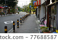 Sidewalk in a quiet residential area 77688587