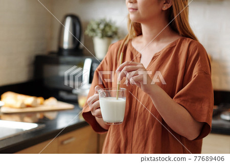 Woman using reusable bamboo straw Woman using reusable bamboo straw 77689406
