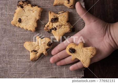 Healthy homemade cookies on wooden background with child's hand Healthy homemade cookies on wooden background with child's hand 77692131