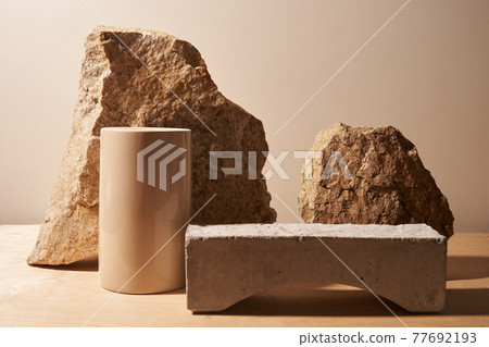 Stone and a piece of tile podium on a beige background 77692193
