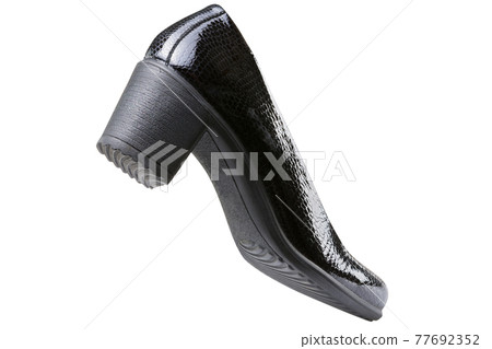 elegant patent women's shoe made of reptile skin, with heels, as if walking, on a white background elegant patent women's shoe made of reptile skin, with heels, as if walking, on a white background 77692352