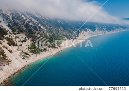 Aerial view of coastline with blue sea and cliffs with clouds. Summer day on Black sea 77693213