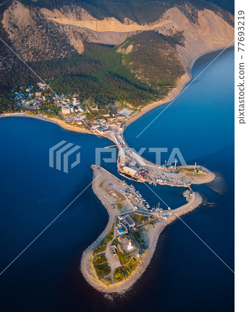 Aerial view of coastline with sea, mountains, canyon and lighthouse on island with sunset light Aerial view of coastline with sea, mountains, canyon and lighthouse on island with sunset light 77693219