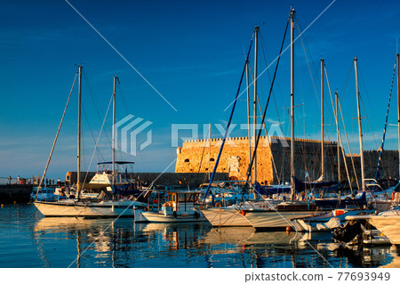 Venetian Fort in Heraklion and moored fishing boats, Crete Island, Greece Venetian Fort in Heraklion and moored fishing boats, Crete Island, Greece 77693949