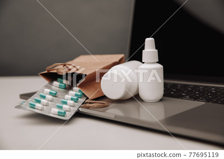 Online pharmacy concept. Shopping cart with pills Online pharmacy concept. Shopping cart with pills 77695119