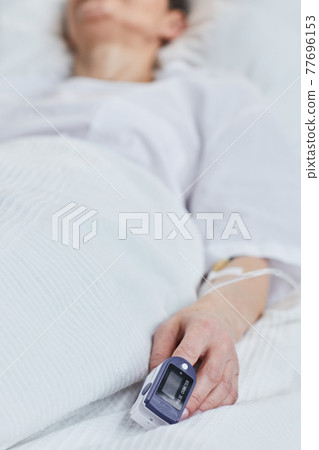 Female patient lying on bed Female patient lying on bed 77696153