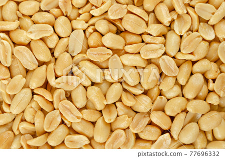 Roasted and salted peanuts, background, from above. Snack food, made from fruits of Arachis hypogaea, also groundnut, goober, pindar or monkey nut, with high oil content. Backdrop. Macro food photo. Roasted and salted peanuts, background, from above. Snack food, made from fruits of Arachis hypogaea, also groundnut, goober, pindar or monkey nut, with high oil content. Backdrop. Macro food photo. 77696332