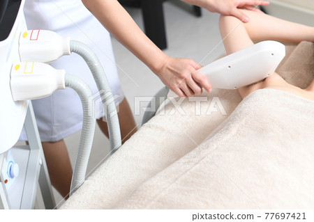 Young woman undergoing armpit hair removal 77697421
