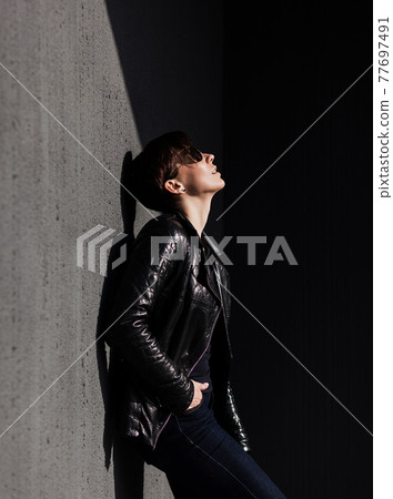 brunette woman in leather clothes 77697491