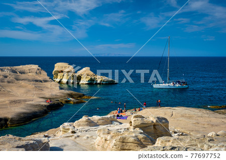 Yacht boat at Sarakiniko Beach in Aegean sea, Milos island , Greece 77697752