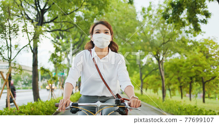 Asian woman commute by bicycle Asian woman commute by bicycle 77699107