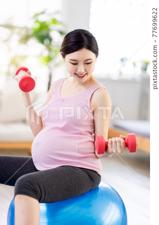 Asian pregnant woman workout 77699622