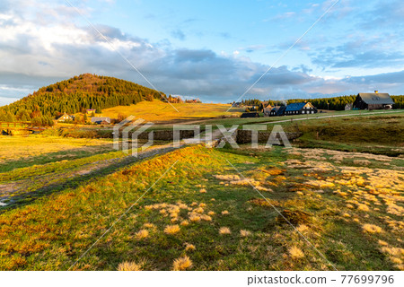 Bukovec mountain above Jizerka village at sunset time. Spring in Jizera Mountains, Czech Republic. 77699796